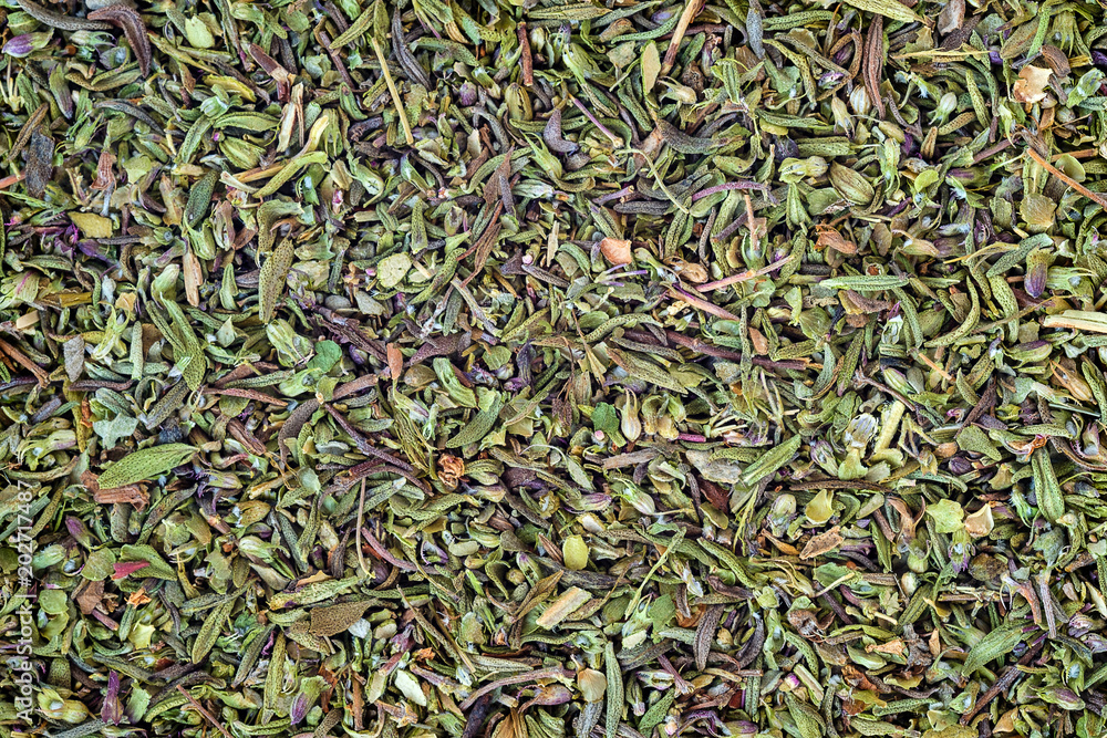 green background and texture of seasoning oregano, close-up around the frame green background and texture of seasoning oregano, close-up around the frame