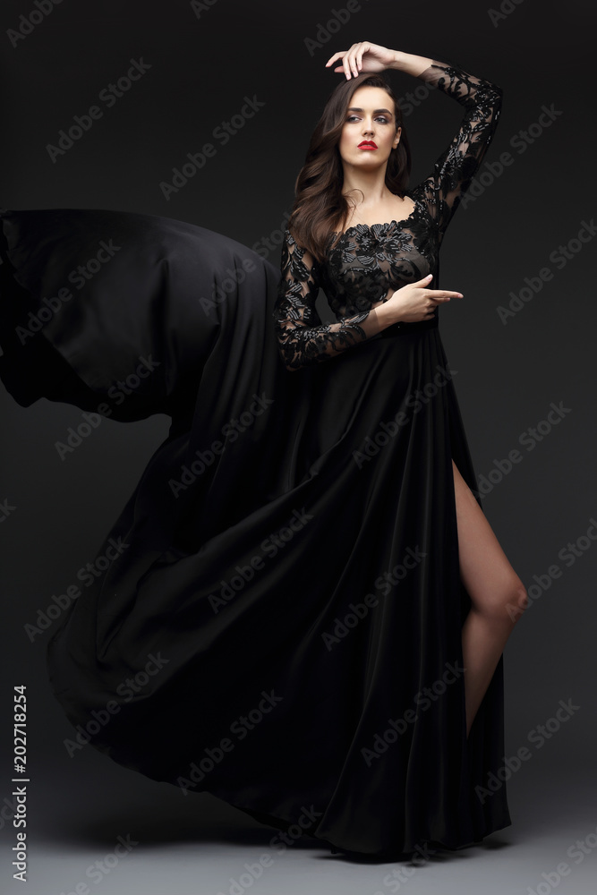 Young elegant woman in long black dress.