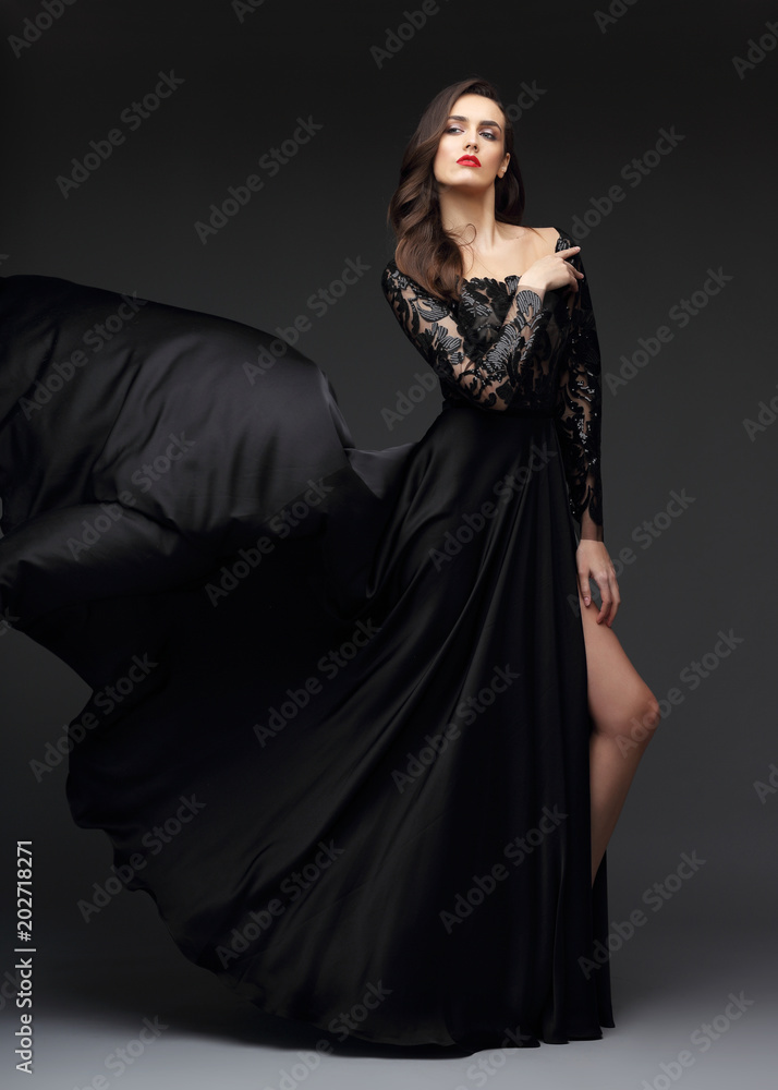 Young elegant woman in long black dress. Young elegant woman in long black dress.