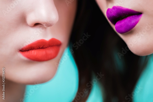 Close up of red and purple lips of two women