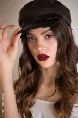 Close up portrait of a beautiful sexy brunette woman with red lips and bright makeup.