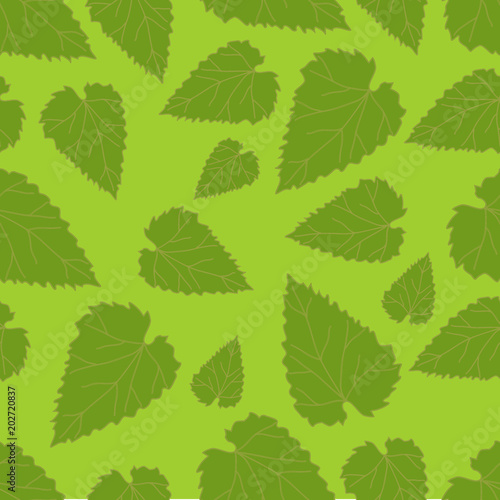 Seamless pattern from green leaves on a green background