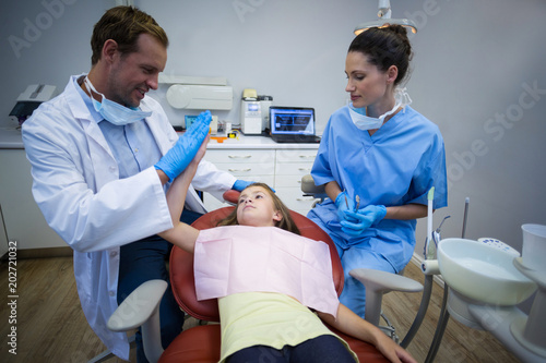 Dentist giving high five to young patient