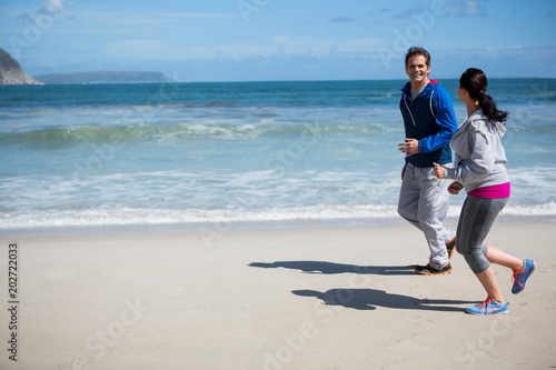 Mature couple jogging on beach