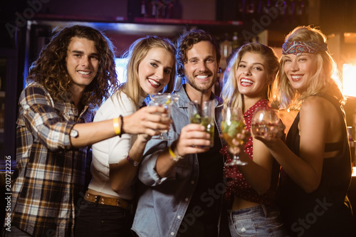 Portrait of friends holding drinks