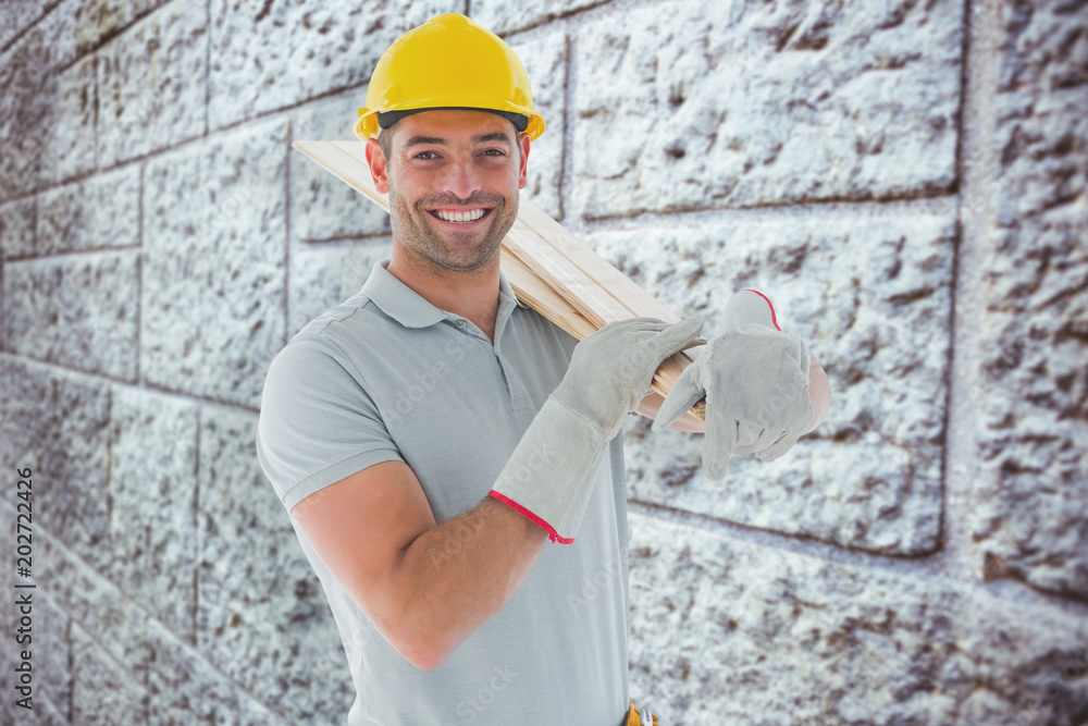Happy carpenter against grey brick wall Happy carpenter against grey brick wall