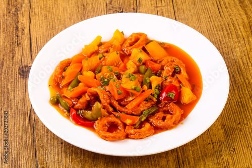 Squid rings in sweet and sour sauce with vegetables