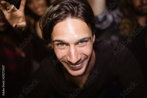 Portrait of smiling man at nightclub