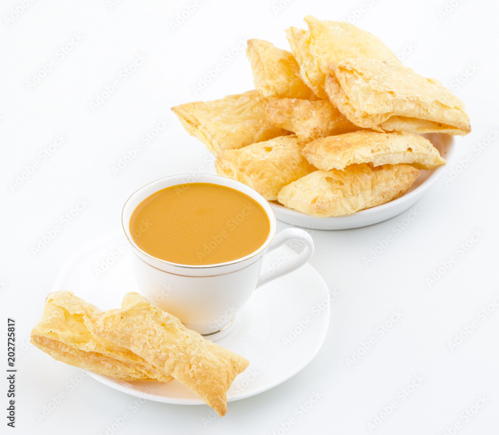 Indian Tea Time Breakfast Khari Also Know as Kharee, Khari Biscuit or Salty Puff Pastry Snacks, Served with Indian Hot Masala Chai or Hot Tea Isolated on White Background Indian Tea Time Breakfast Khari Also Know as Kharee, Khari Biscuit or Salty Puff Pastry Snacks, Served with Indian Hot Masala Chai or Hot Tea Isolated on White Background