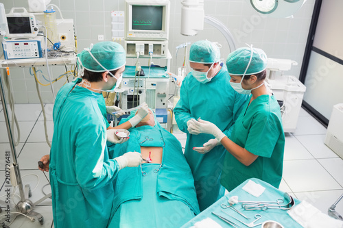 High angle view of surgeon operating an uncounscious patient 