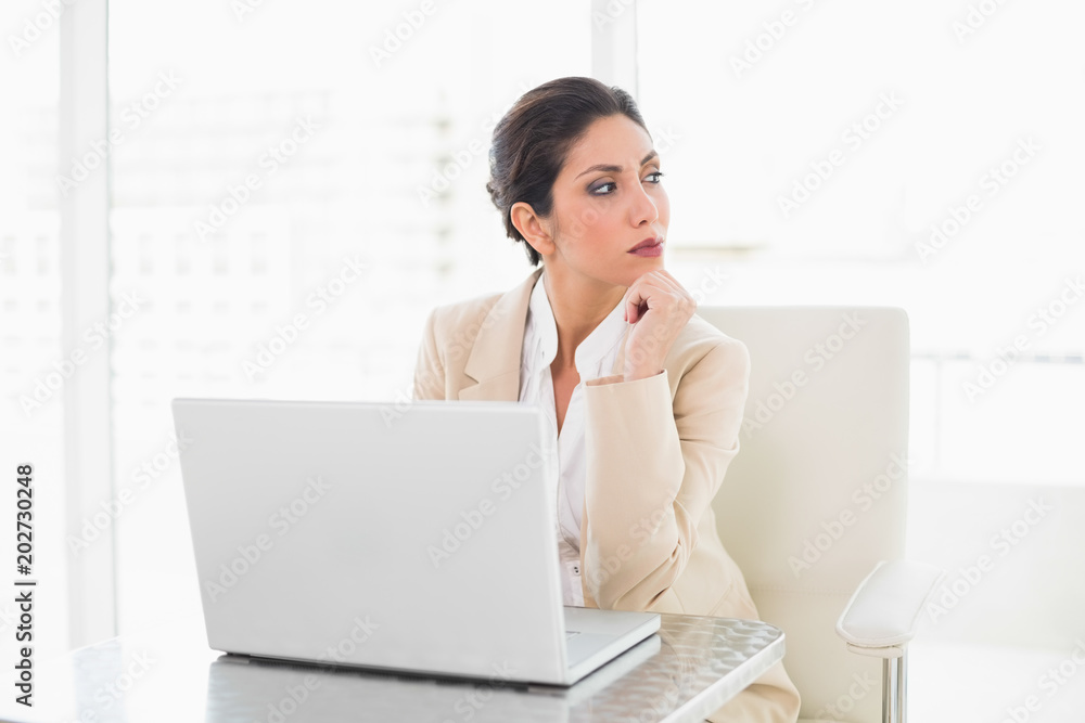 Thoughtful businesswoman working with a laptop Thoughtful businesswoman working with a laptop