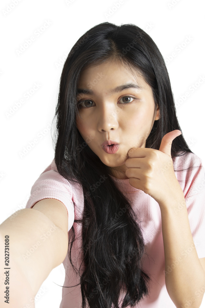 Asian girl taking selfie photo while makinging funny face and took her thumb up. Asian girl taking selfie photo while makinging funny face and took her thumb up.
