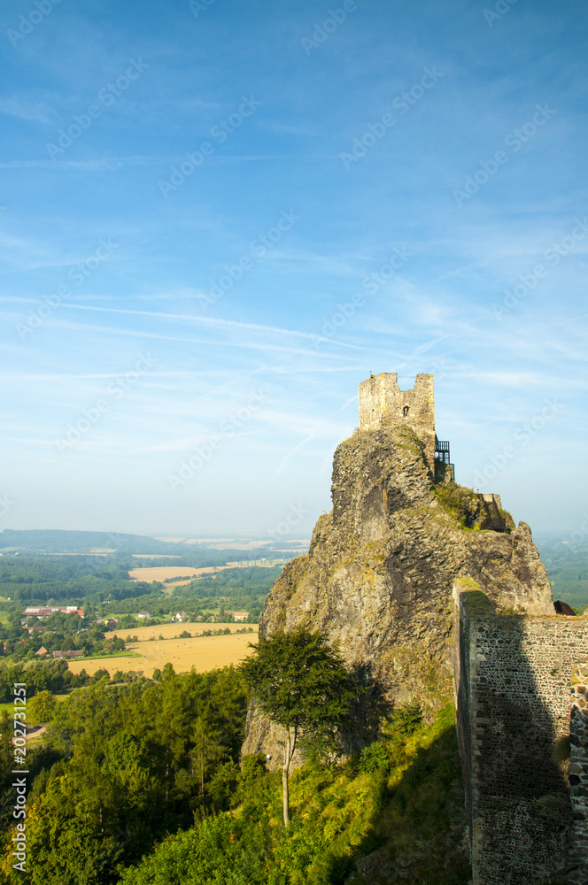 View on old medieval castle Trosky and its tower Baba above summer trees. Bohemian Paradise, Czech Republic