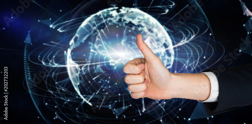 Hand showing thumbs up against global technology background in blue