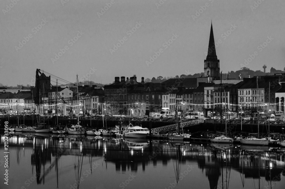 Panoramic view of a cityscape at night with illumination in Waterford, Ireland. Black and white