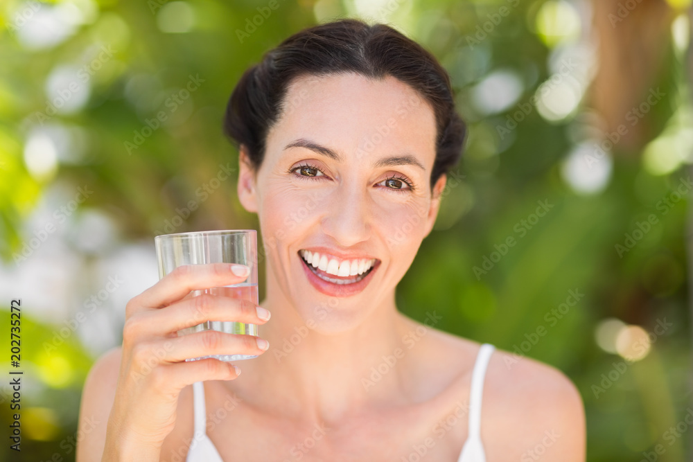 woman in white having a glass of water woman in white having a glass of water