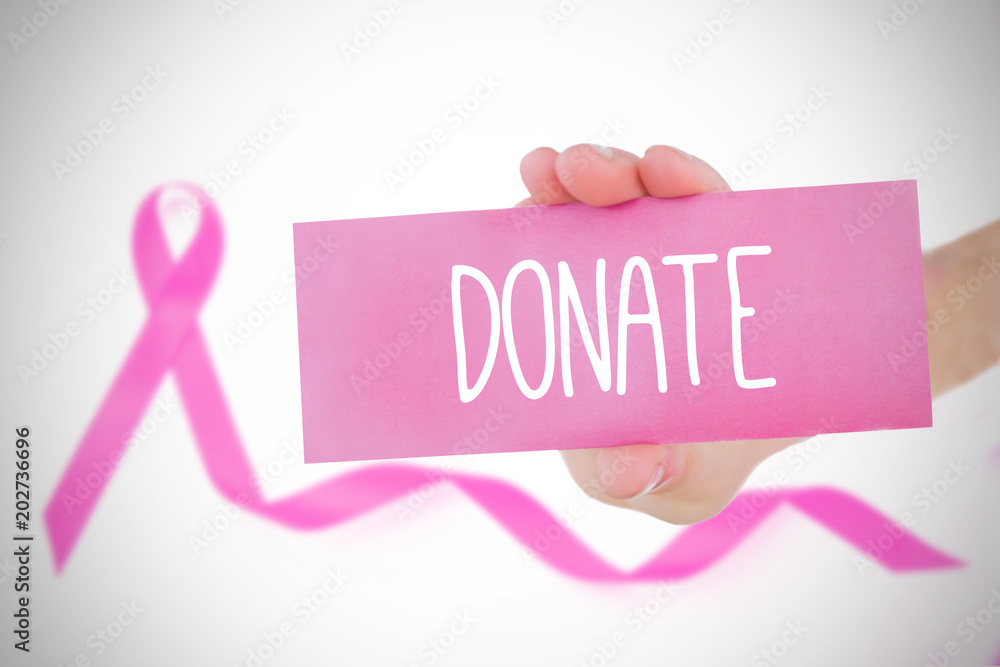 Young woman holding card against pink awareness ribbon with trail Young woman holding card against pink awareness ribbon with trail