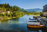 June, 8th, 2016 - Skadar Lake, Montenegro. Fishing boats, mountains and shore houses on Tsrnoyevicha river near Skadarsko Jezero in Montenegro.