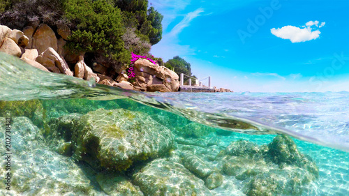 Split underwater view of Capriccioli beach coastline
