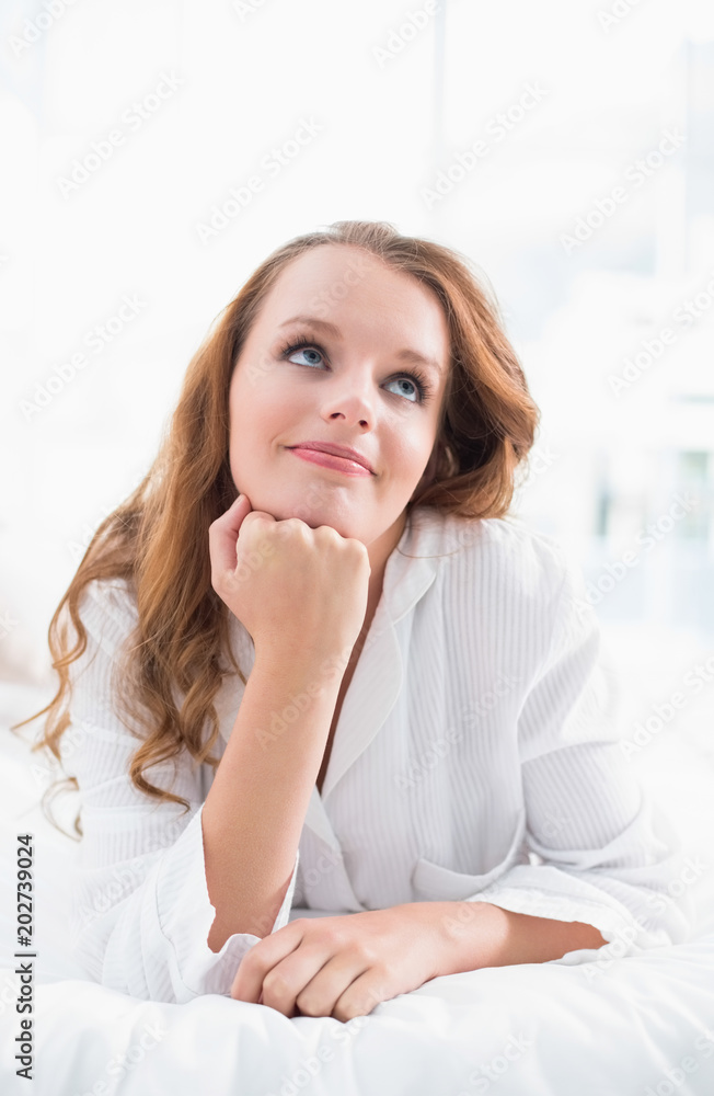 Thoughtful pretty woman lying on her bed Thoughtful pretty woman lying on her bed