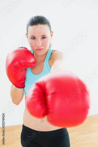Beautiful woman in red boxing gloves at fitness studio © WavebreakmediaMicro