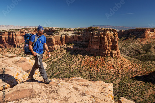 Hiker is sitting on the cliff in Colorado National monument, USA