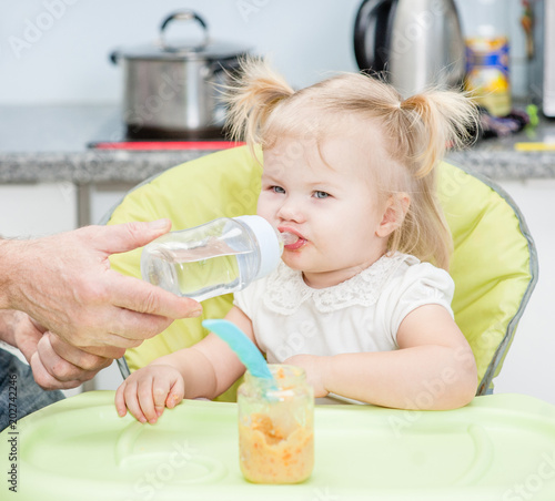 Father gives daughter drink water bottles
