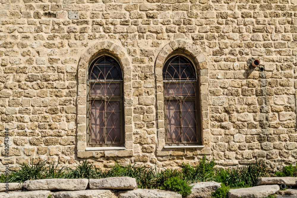 Vintage lancet windows on the background sandstone bricks
