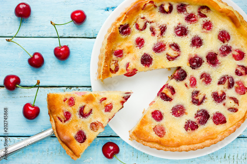 Clafoutis with cherry on a blue wooden background