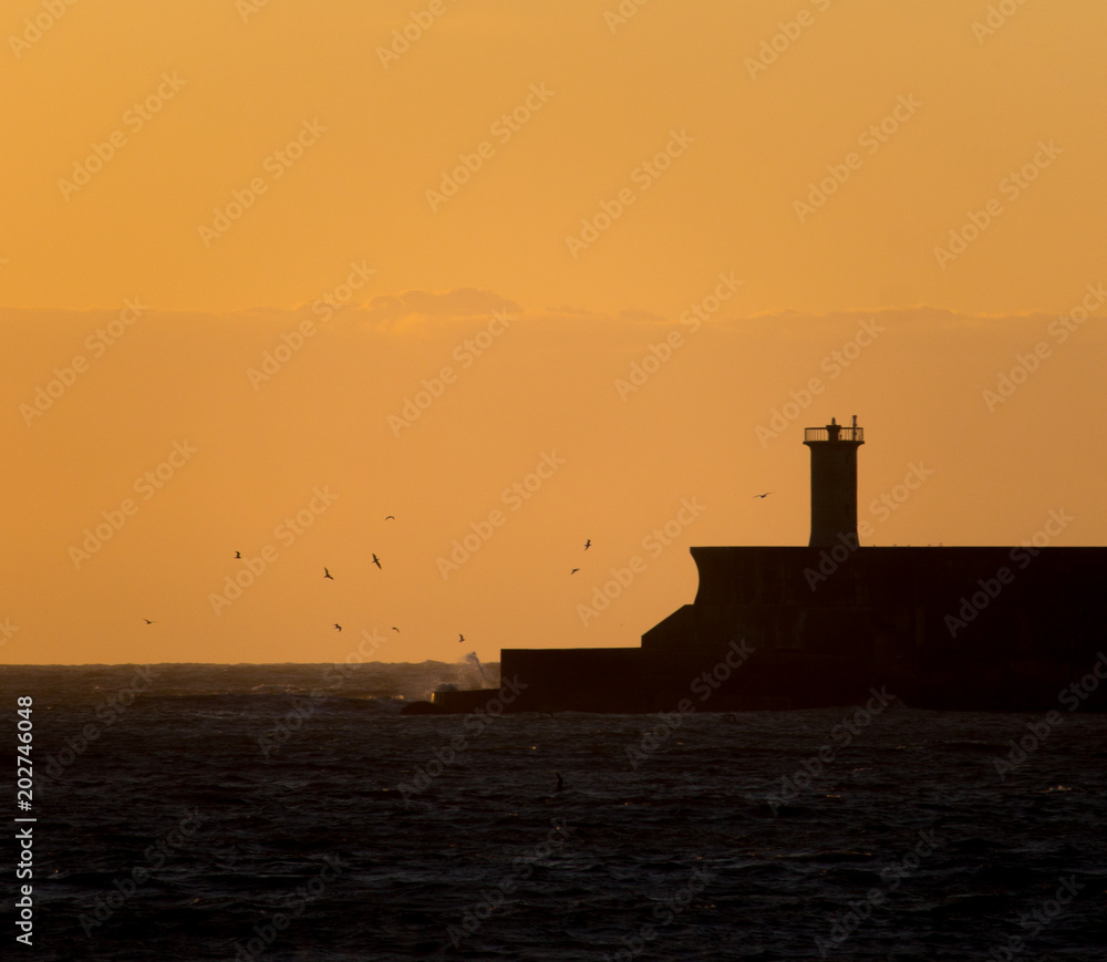 Silhouetted Lighthouse During a Sunset