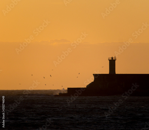 Silhouetted Lighthouse During a Sunset
