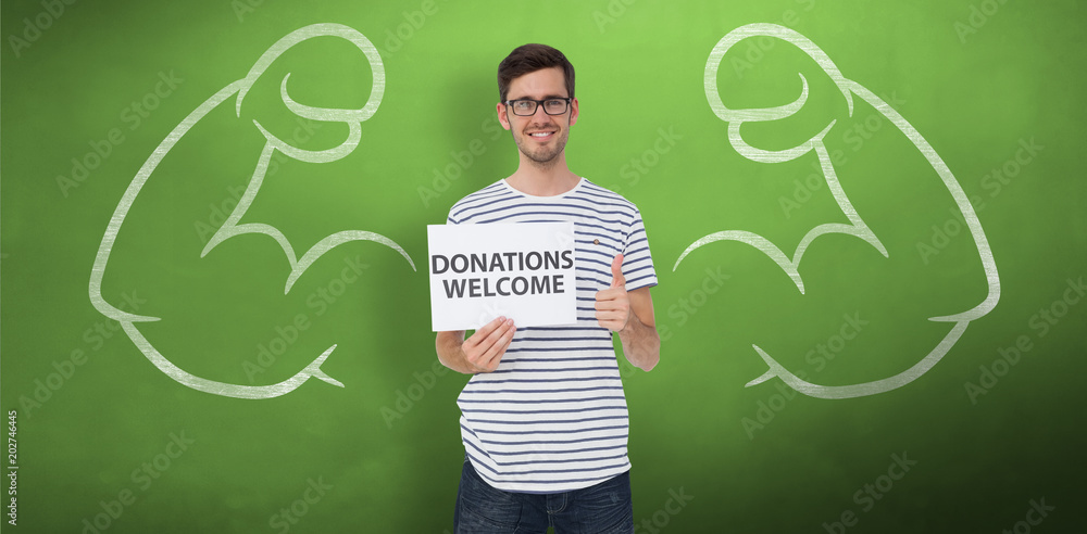 Man holding a donation welcome note while gesturing thumbs up against green chalkboard
