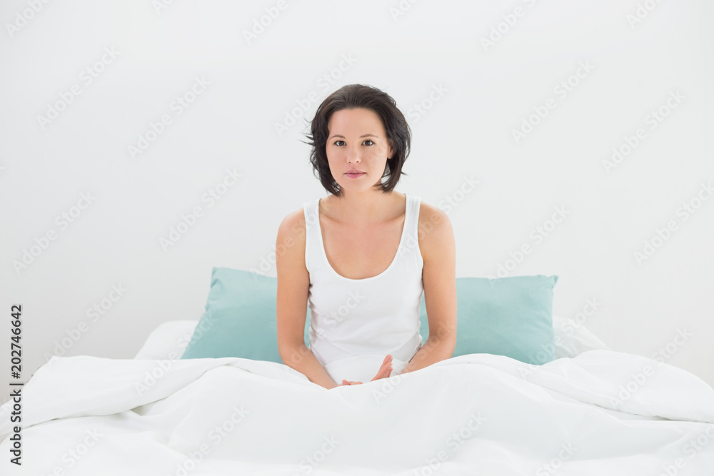 Portrait of a serious woman sitting in bed Portrait of a serious woman sitting in bed