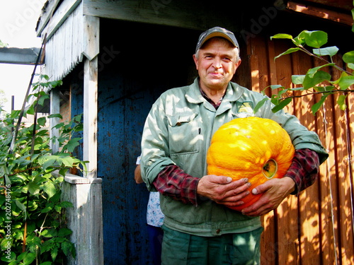 Farmer with a big pumpkin