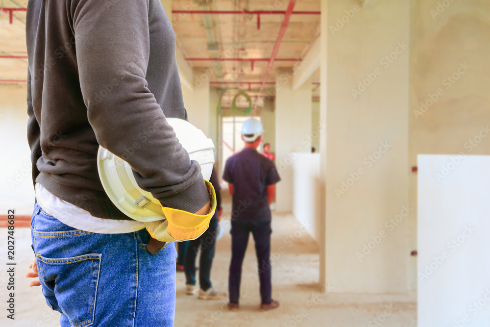 engineering hand holding white safety hat interior  renovate house working construction site in building with copy space add text