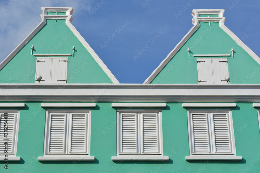 Architecture detail of pastel green wall and white louvers. Willemstad, Curaçao.