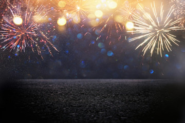 abstract black and gold glitter background with fireworks and asphalt floor or stage. christmas eve, 4th of july holiday concept.