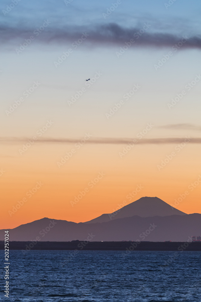 Mountain Fuji and Tokyo bay at sunset time in winter season.Tokyo Bay is a bay located in the southern Kanto region of Japan, and spans the coasts of Tokyo, Kanagawa Prefecture, and Chiba Prefecture.