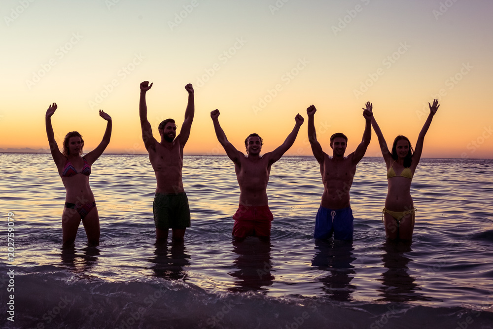 Happy friends having fun in the water 