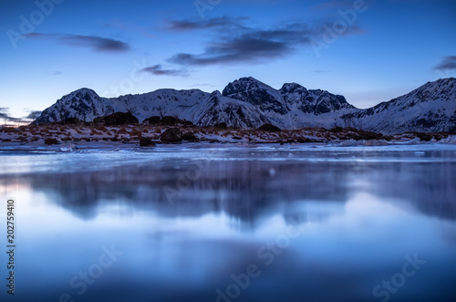 Mountain ridge and reflection in the lake. Natural landscape in the Norway