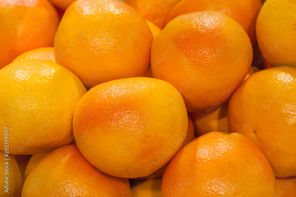Close up view of a pile of grapefruits in the store as background, texture Close up view of a pile of grapefruits in the store as background, texture