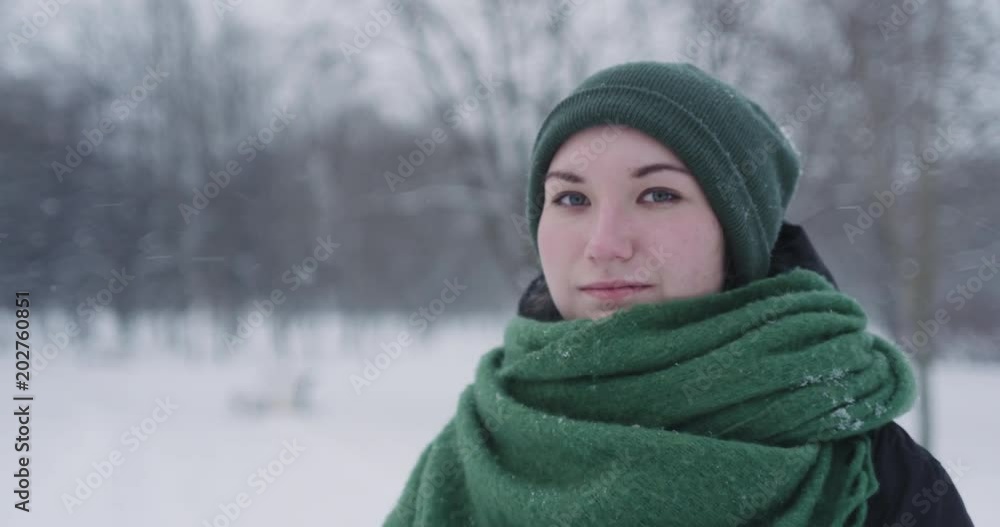 Slow motion portrait of teen girl standing in park on a winter day Slow motion portrait of teen girl standing in park on a winter day