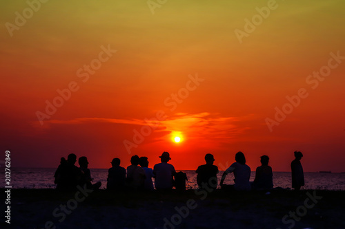 silhouette family meeting and looking sunset on beach