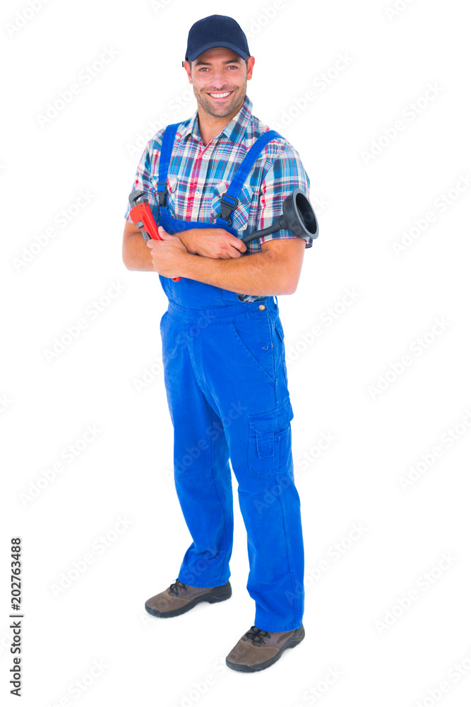 Male plumber holding plunger and wrench Male plumber holding plunger and wrench