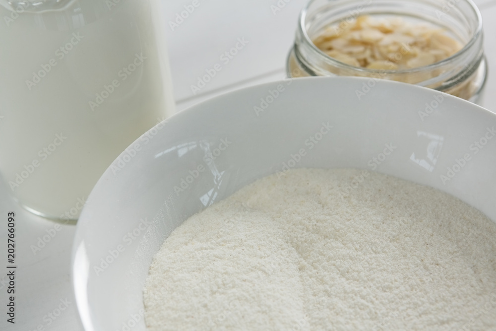 Bowl of semolina with milk bottle