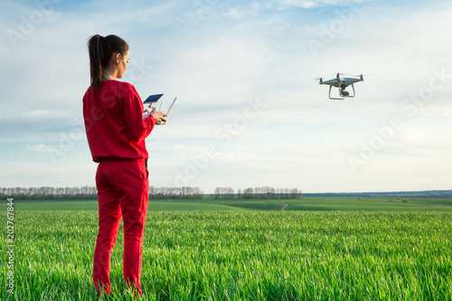 Female flying a drone at the field
