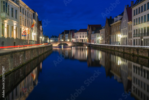 View of a canal and old historical buildings in Bruges, Belgium at dusk © beataaldridge