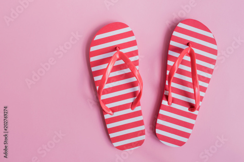 Flip flops on a pink background