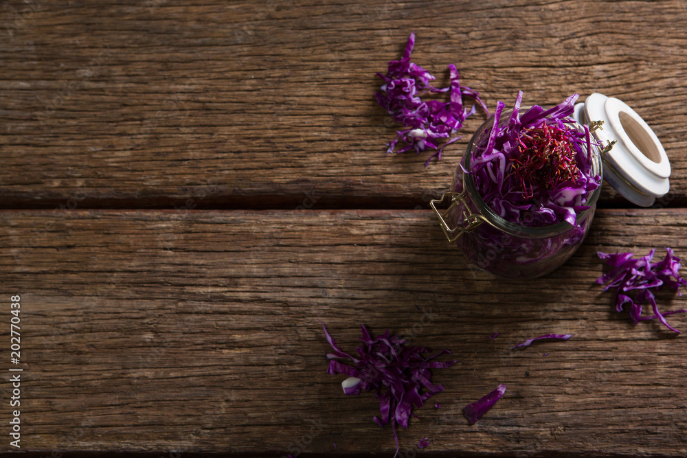 Chopped red cabbage in jar on wooden table Chopped red cabbage in jar on wooden table