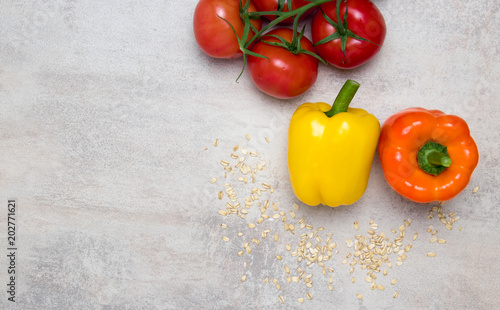 Tomatoes and pepper on table.